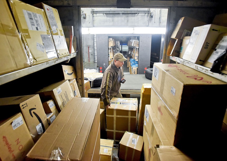 His Delivery Information Acquisition Device (DIAD) in hand, UPS driver Andrew Hancock checks the load before leaving on the day's deliveries at the UPS depot on Nov. 3, 2015 in Jackson, Pa. (Bob Donaldson/Pittsburgh Post-Gazette/TNS)